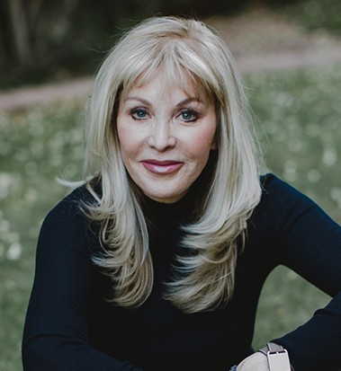 Photo of Marlise Karlin smiling and wearing a black top